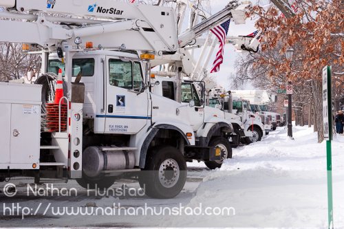 A row of cherry pickers along Summit Avenue